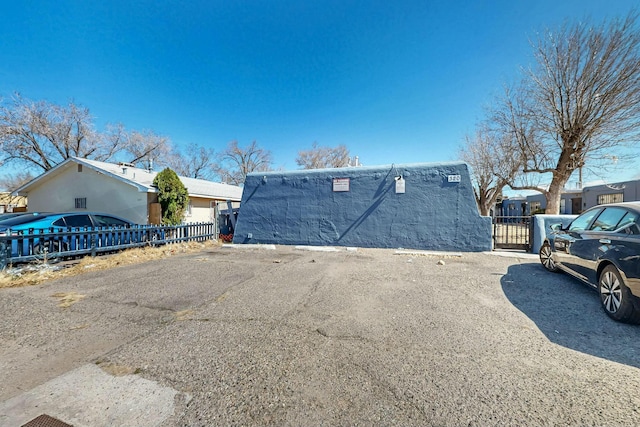 view of property exterior featuring a gate and fence