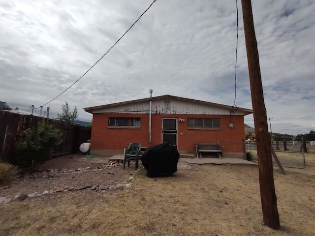 rear view of house with fence