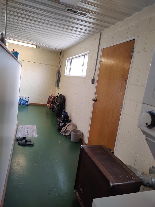 interior space featuring visible vents and concrete block wall