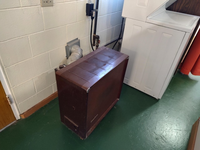 details with washer / dryer, concrete flooring, and concrete block wall