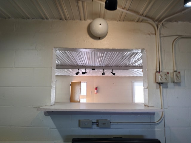 kitchen featuring light countertops and concrete block wall