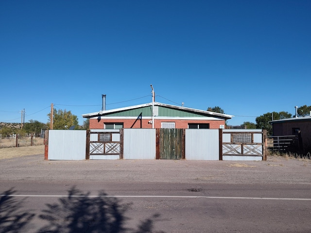 view of property with a detached garage and fence