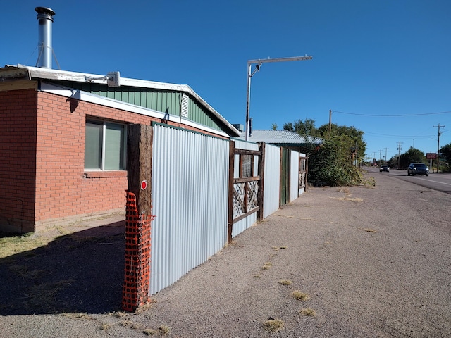 view of side of home with brick siding