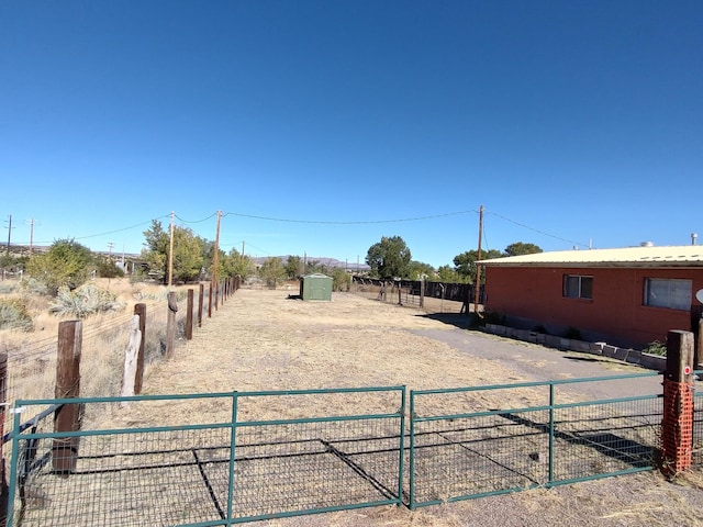 view of yard featuring an outbuilding and fence