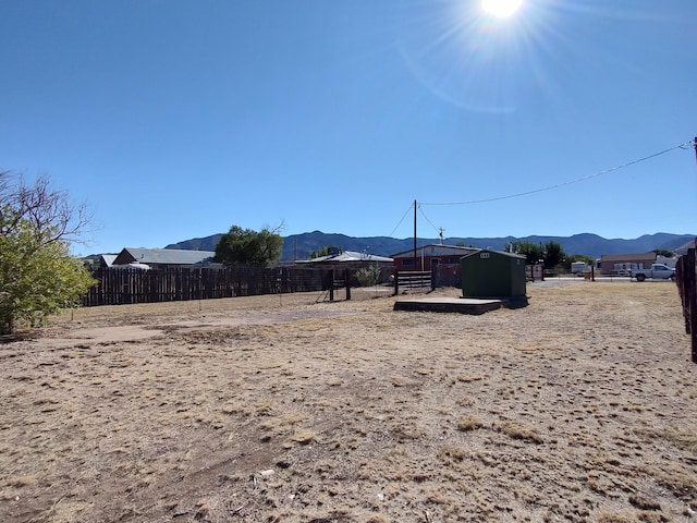 view of yard with a mountain view and fence