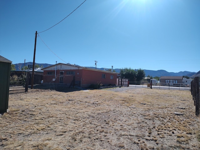 view of yard featuring a mountain view and fence