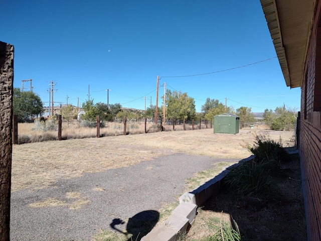 view of yard featuring a storage unit and an outdoor structure