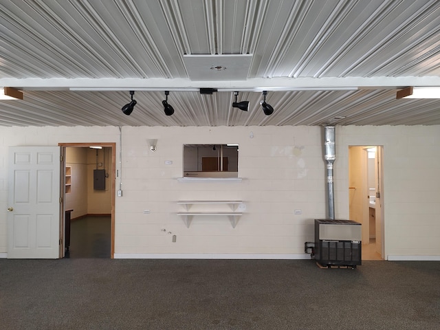 interior space featuring electric panel and concrete block wall