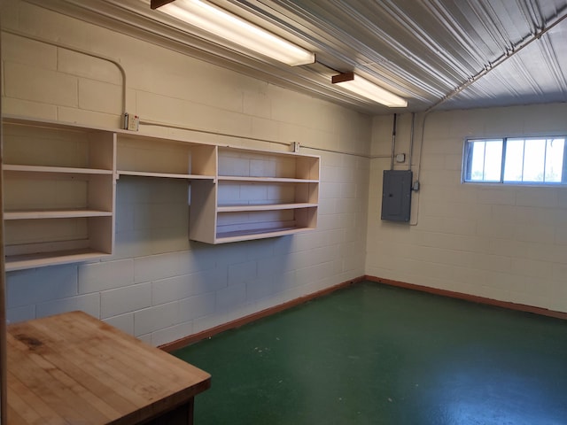 interior space featuring electric panel and concrete block wall