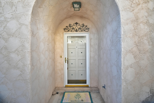 entrance to property featuring stucco siding