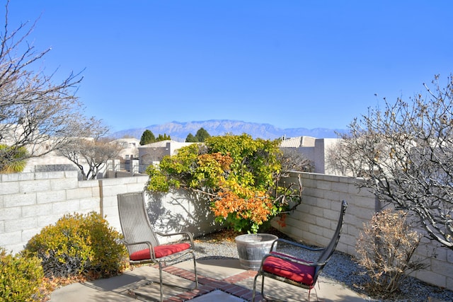 view of patio featuring fence private yard and a mountain view