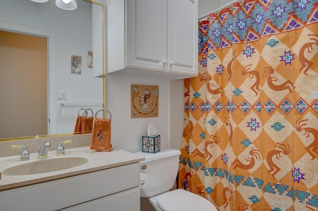 bathroom with curtained shower, vanity, and toilet