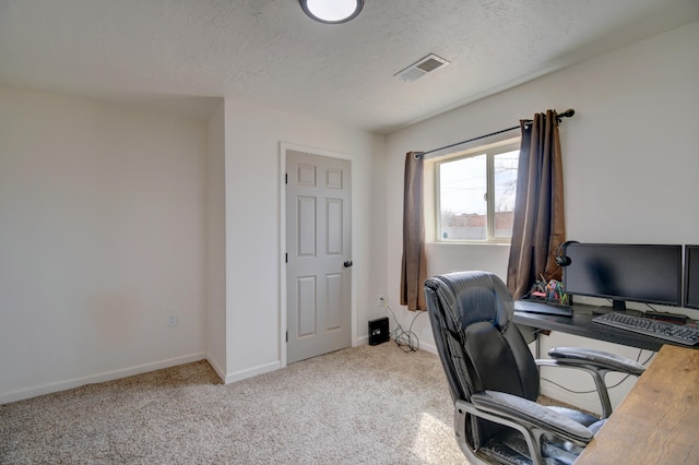 carpeted office with baseboards, visible vents, and a textured ceiling