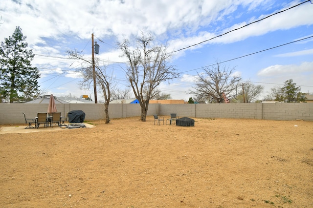 view of yard with a fenced backyard and outdoor dining area