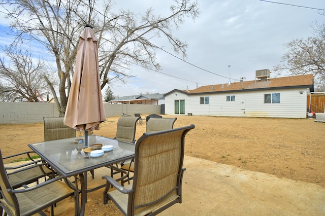 view of patio featuring a fenced backyard and outdoor dining area