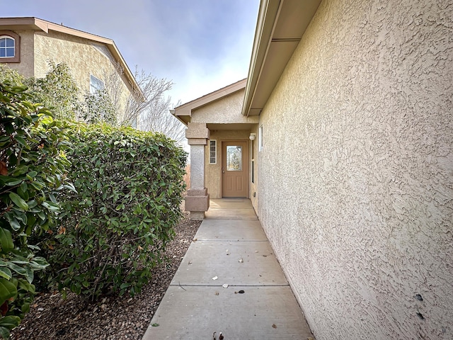 entrance to property with stucco siding