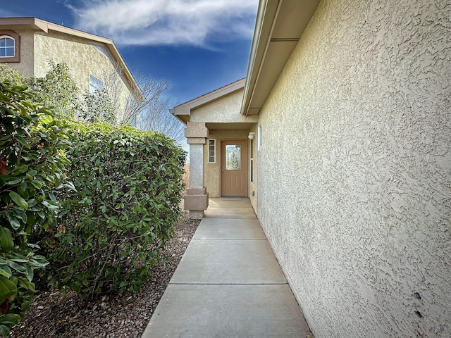 property entrance with stucco siding