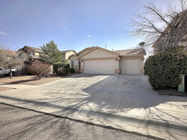 view of front of house with an attached garage, driveway, and stucco siding