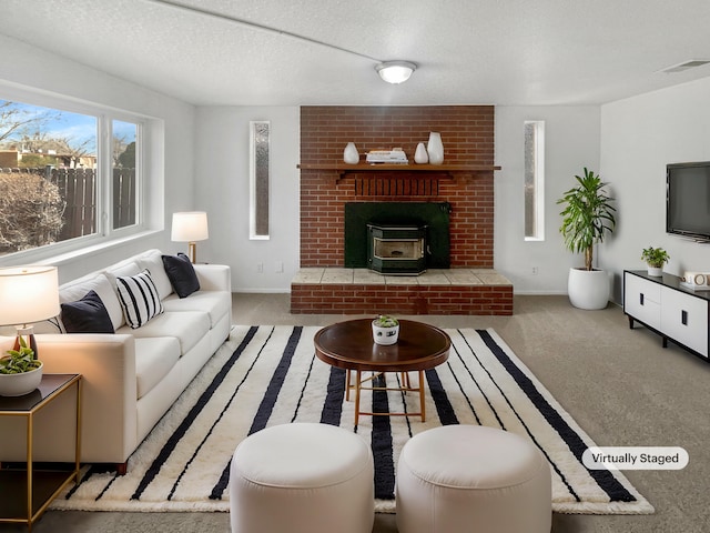 living area with a textured ceiling, carpet floors, visible vents, and baseboards