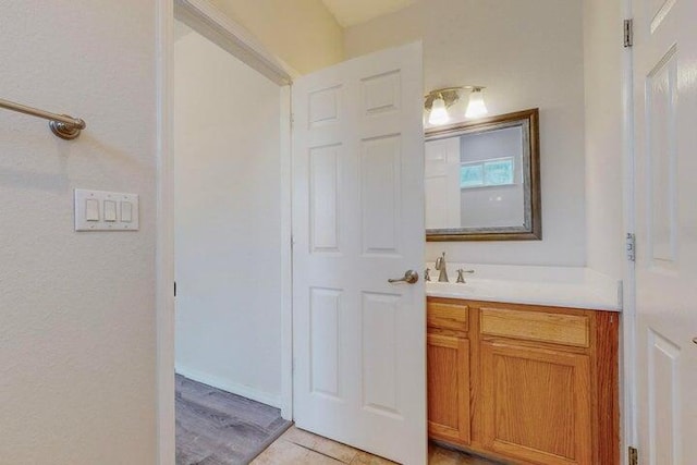 bathroom featuring tile patterned flooring and vanity