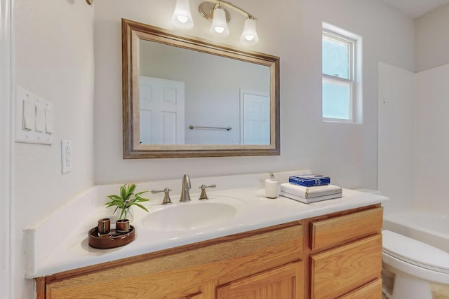 bathroom with toilet, shower / bathing tub combination, and vanity