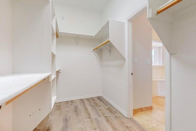 spacious closet with light wood finished floors