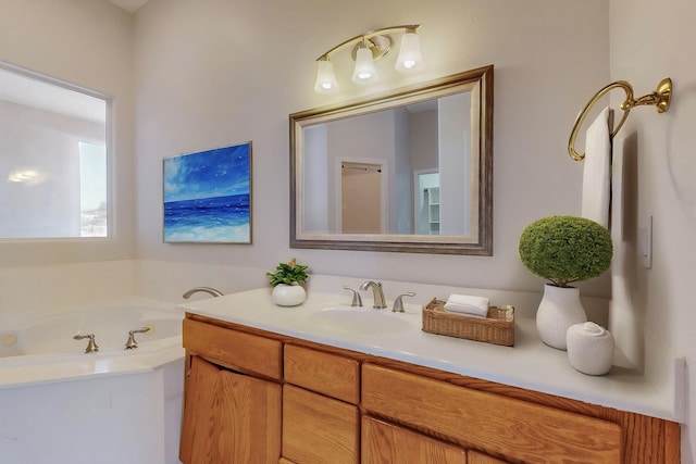 bathroom featuring a garden tub and vanity