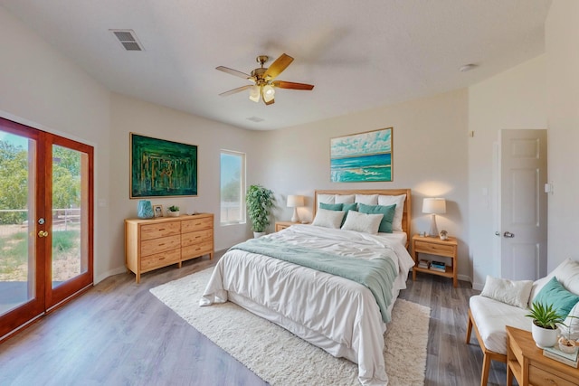 bedroom featuring visible vents, baseboards, light wood-style flooring, access to outside, and french doors