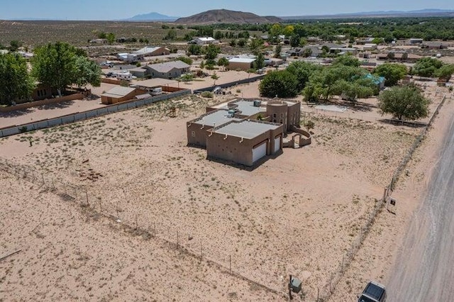 drone / aerial view with view of desert and a mountain view