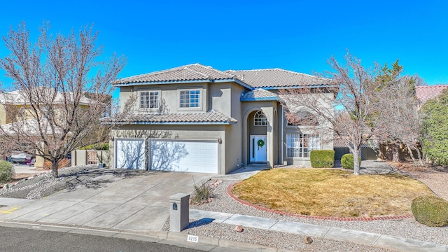 view of front of house featuring an attached garage, a tile roof, concrete driveway, stucco siding, and a front lawn