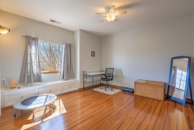 interior space featuring a ceiling fan, a wealth of natural light, visible vents, and light wood-style flooring