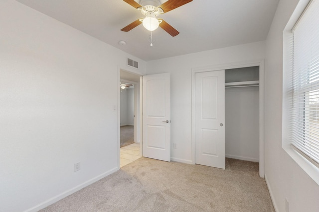 unfurnished bedroom with visible vents, baseboards, light colored carpet, and a closet