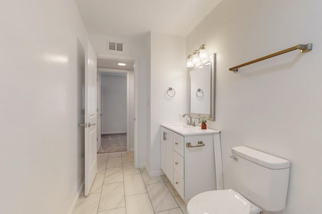 bathroom with visible vents, baseboards, toilet, and vanity