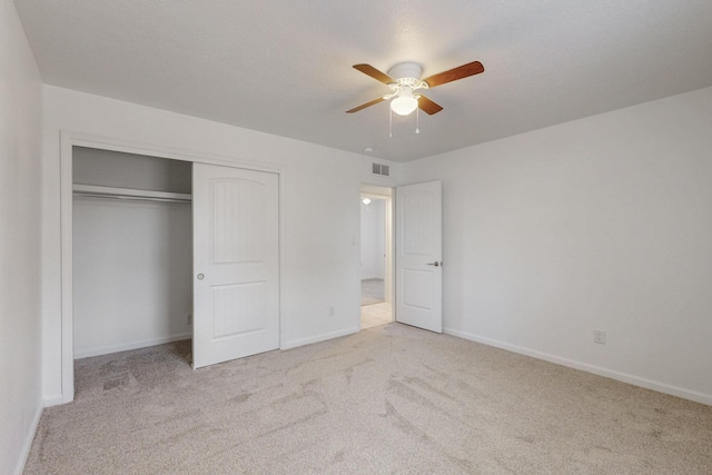 unfurnished bedroom with visible vents, a closet, carpet, baseboards, and ceiling fan