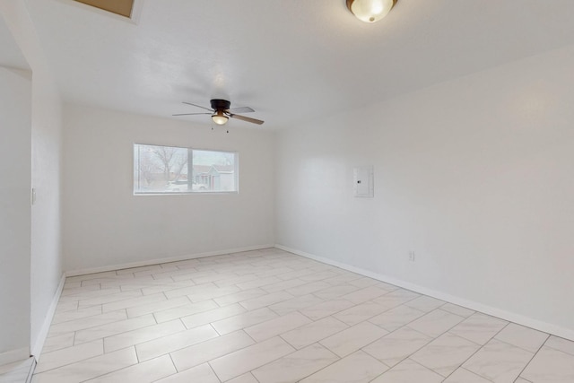 unfurnished room featuring a ceiling fan and baseboards