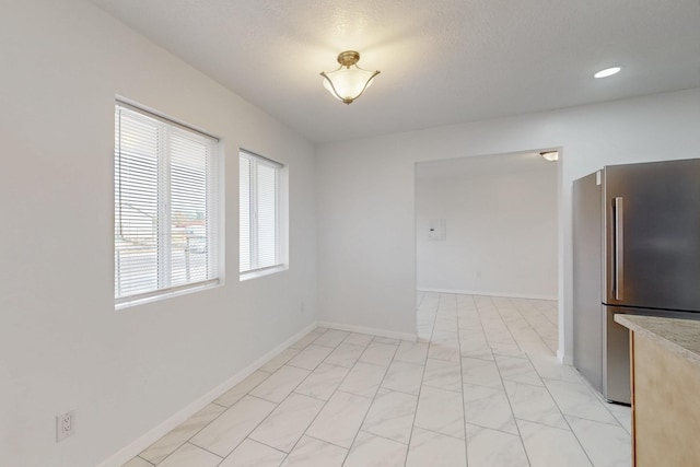 empty room with recessed lighting and baseboards