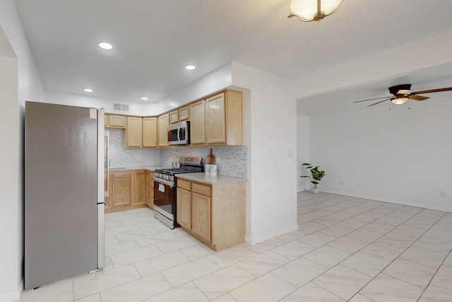 kitchen with visible vents, light brown cabinets, tasteful backsplash, stainless steel appliances, and light countertops