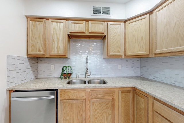 kitchen with light brown cabinets, visible vents, and a sink