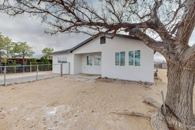 exterior space with fence and stucco siding