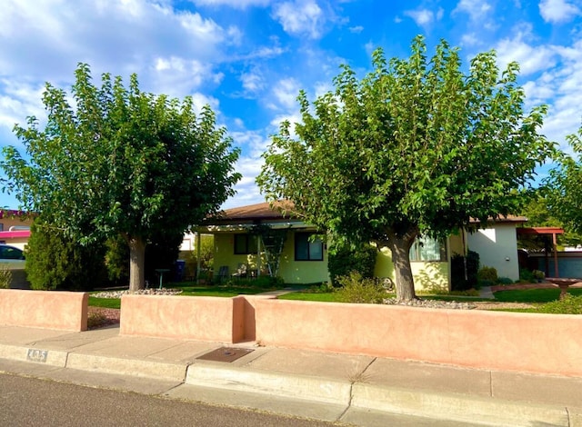 obstructed view of property featuring stucco siding