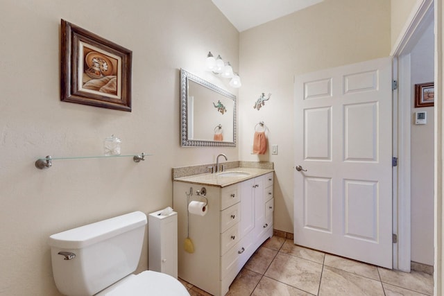 bathroom with vanity, toilet, and tile patterned floors