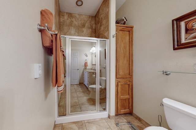 bathroom with a stall shower, vanity, and toilet