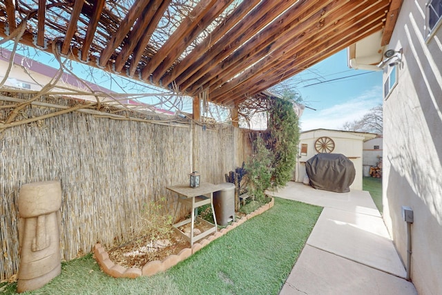 view of yard with an outbuilding, a patio, a storage shed, and a fenced backyard