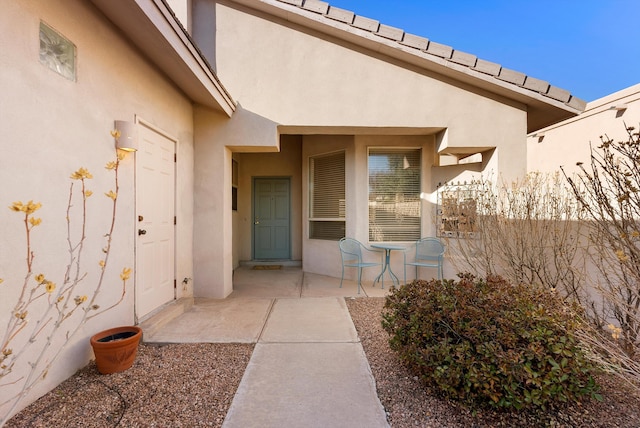 property entrance with stucco siding