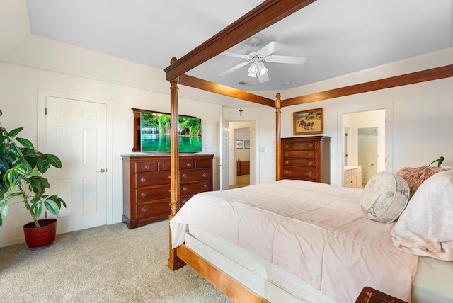 bedroom featuring visible vents, ceiling fan, light carpet, beam ceiling, and ensuite bathroom