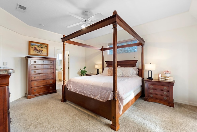 bedroom featuring a ceiling fan, baseboards, visible vents, carpet floors, and ensuite bathroom