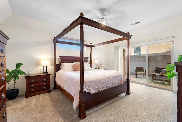 bedroom with access to exterior, visible vents, carpet floors, and ceiling fan