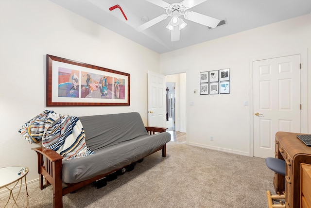 living area featuring ceiling fan, visible vents, baseboards, and light carpet