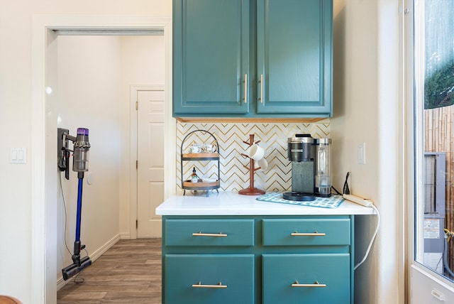 interior space featuring tasteful backsplash, baseboards, and wood finished floors