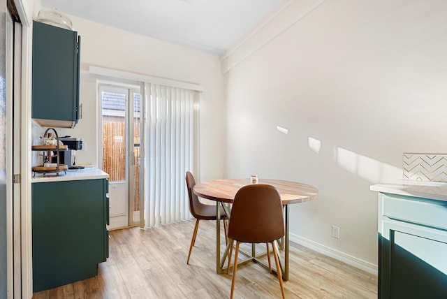 dining area featuring baseboards and light wood-style floors